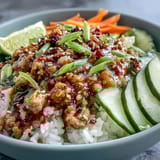 Lime wedges and sesame seeds garnish these vibrant bowls, perfect for a quick, flavorful Asian-inspired weeknight dinner.