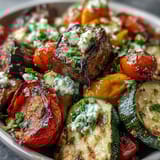 A platter of Roasted Mediterranean Greek Vegetables served as a vegetarian main with warm pita bread.