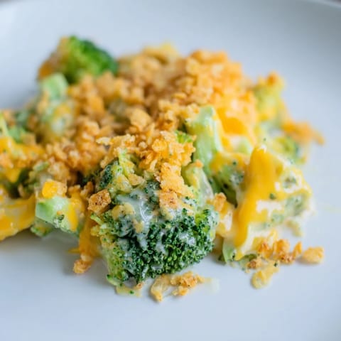 A steaming dish of Broccoli Casserole, featuring tender broccoli under a crisp, cheesy crust.