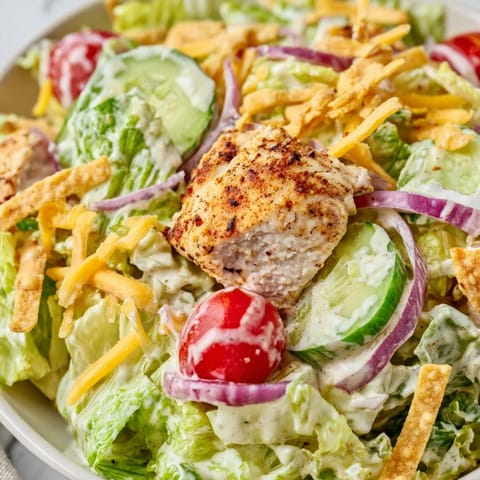 Fresh cherry tomatoes, cucumber, and red onion add color and crunch to the vibrant salad.  