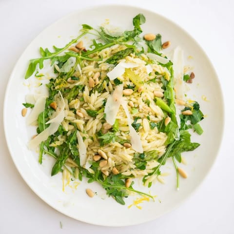 Shaved asparagus ribbons and tender orzo pasta tossed with zesty lemon-olive oil dressing, topped with Parmesan and pine nuts.  